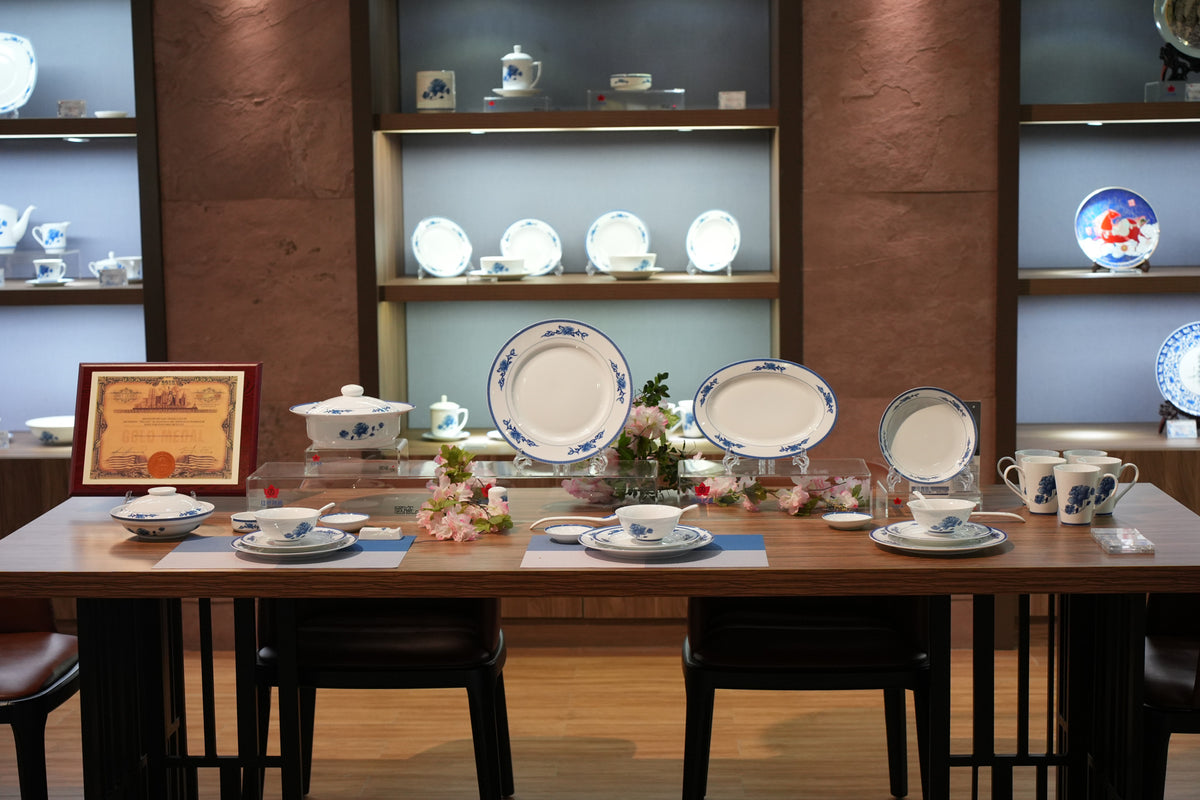 Original photograph of a porcelain collection displayed across a table in an interior