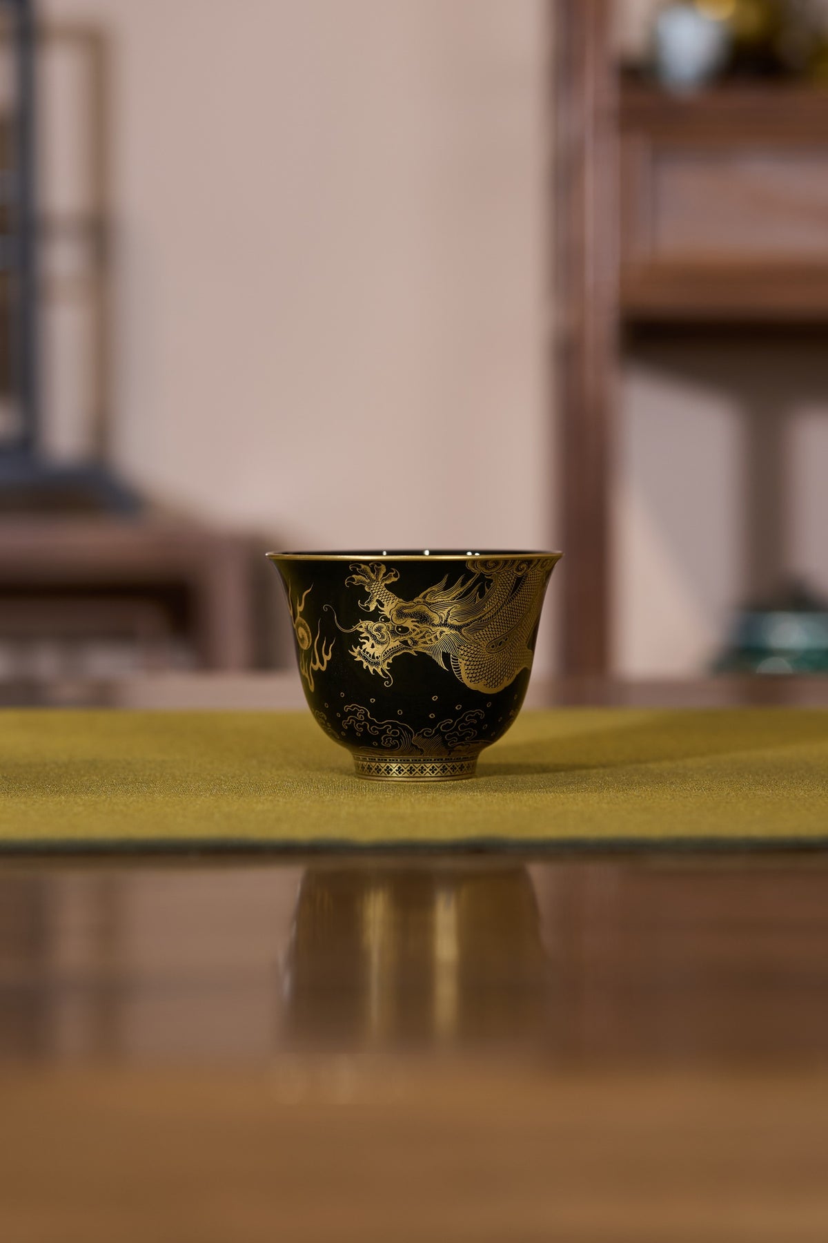 Original photograph of gold-coloured decoration on a dark glazed covered bowl