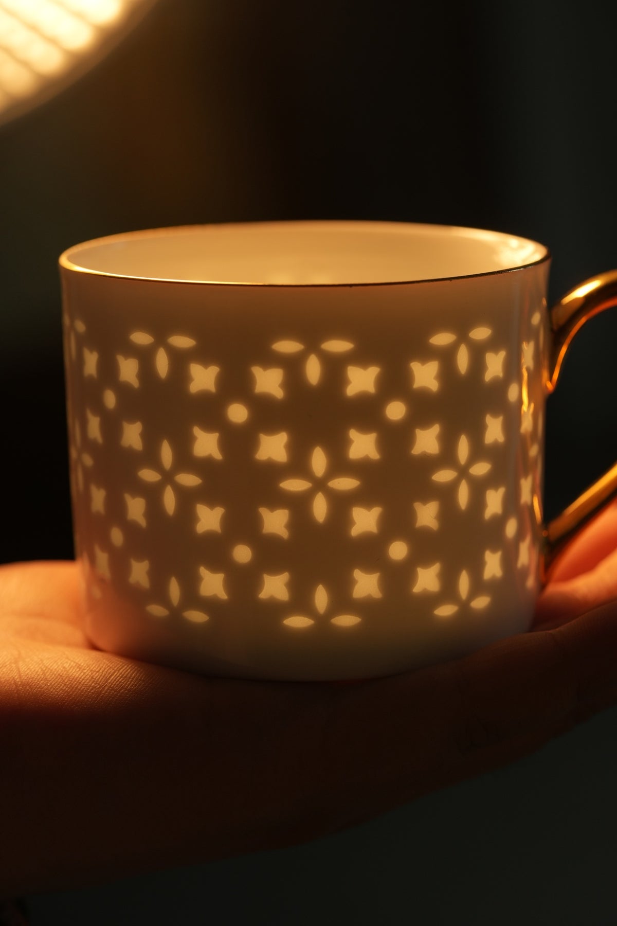 Original company photograph of light revealing the pattern in a white cup